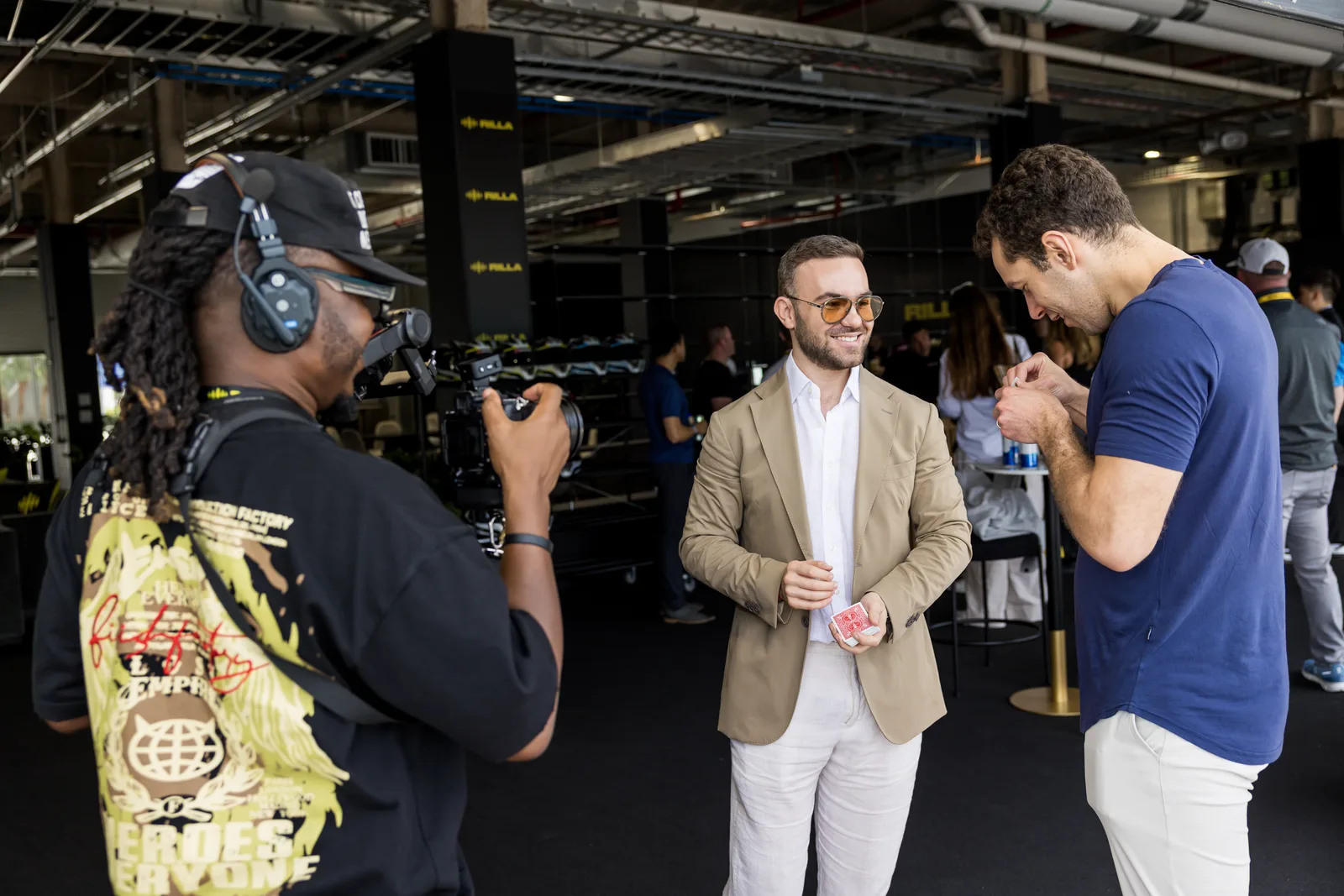 Matteo Cammisa performing for a guest in the Miami garages as a videographer captures the moment