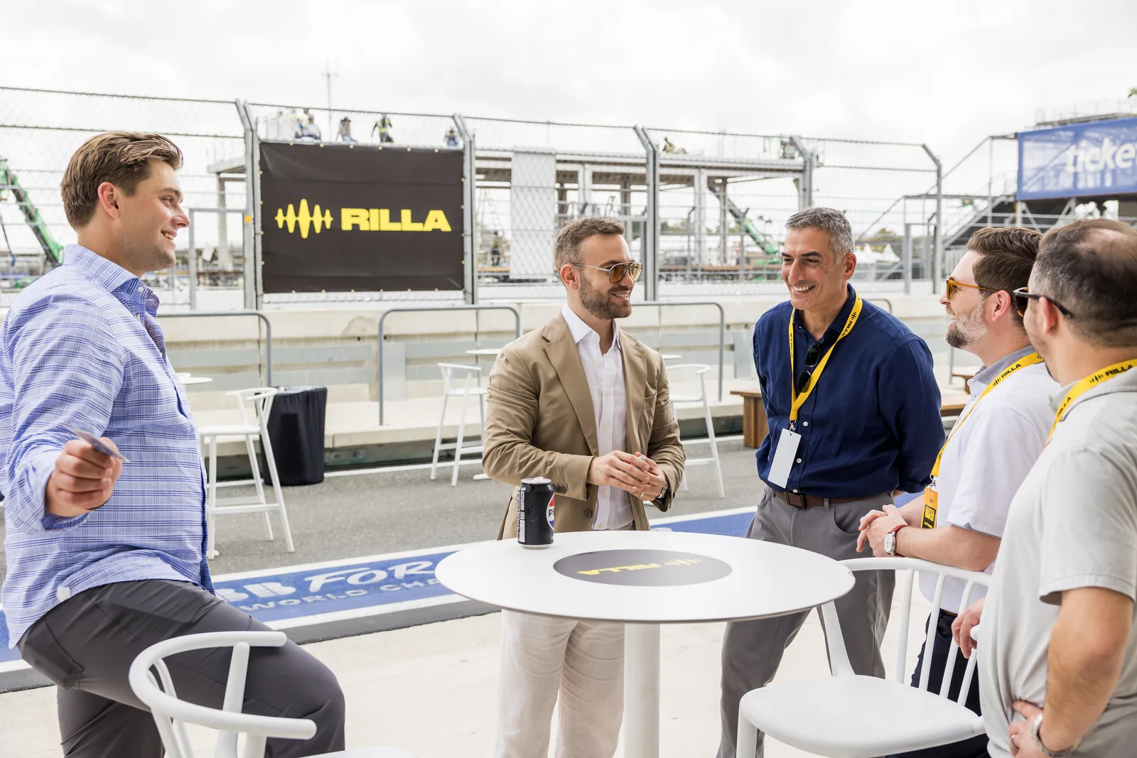 Guests gathered around Matteo Cammisa during a close-up performance on the paddock terrace in Miami