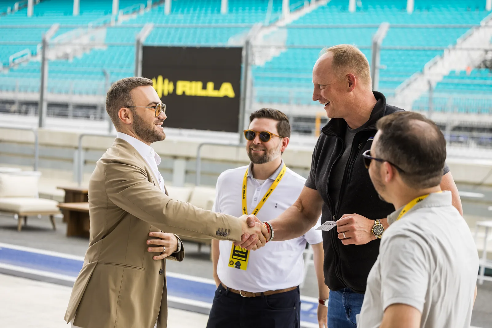 Matteo Cammisa shaking hands with guests beside the circuit at the Miami International Autodrome