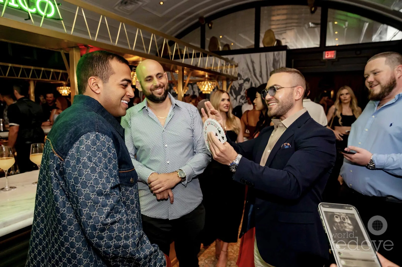 Jay Shirodkar and guests watching Matteo Cammisa's close-up magic at the Jay's Steakhouse pre-opening