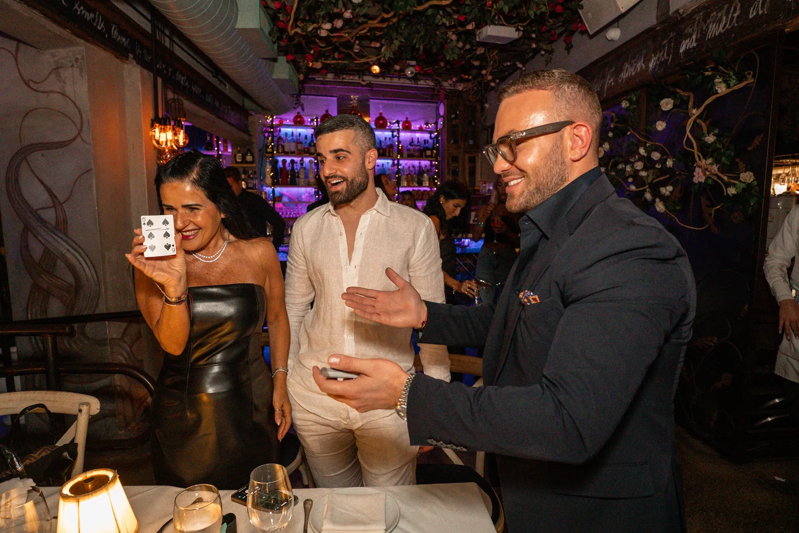 Matteo Cammisa performing a card effect tableside for guests at Kiki on the River, Miami